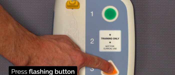 If a shock is required, after the AED has charged press the flashing button to deliver a shock