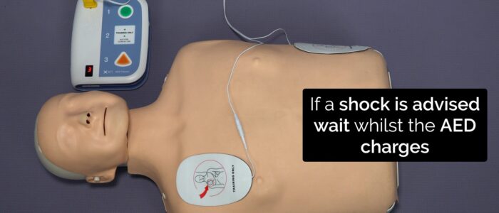 If a shock is required, wait for the AED to charge